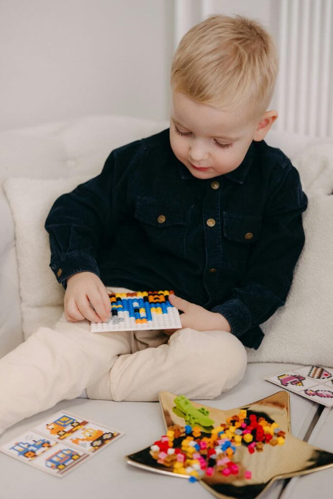 Young child sorting colorful items on a table during a calm activity