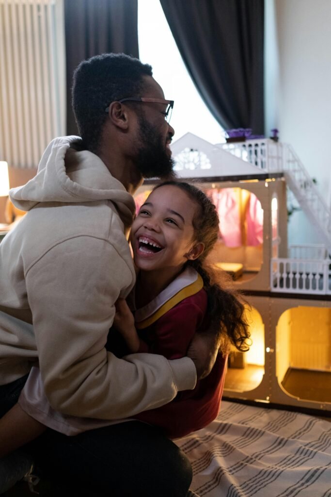 Child laughing while playing a quick indoor game with a parent