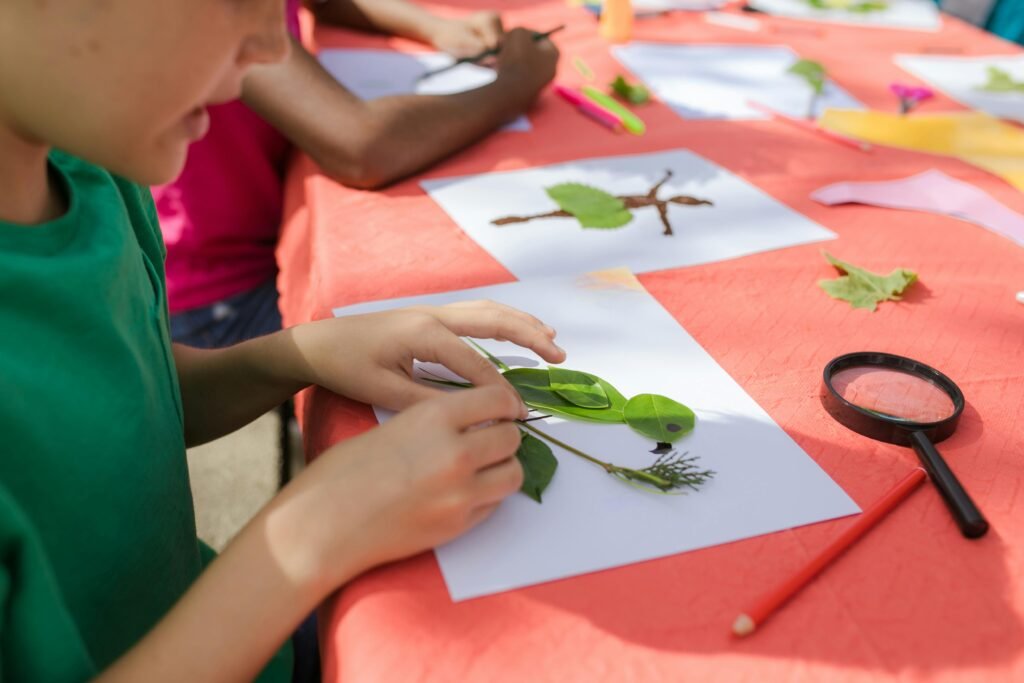  Child independently working on a nature art project at a table with colorful supplies